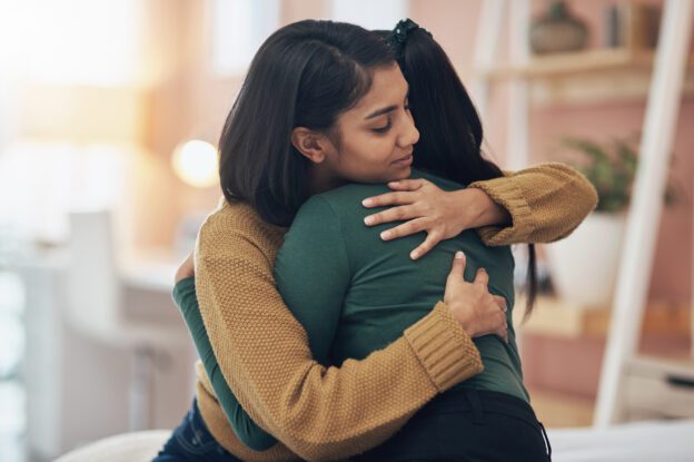 women hugging after friend discover how to help someone with meth addiction